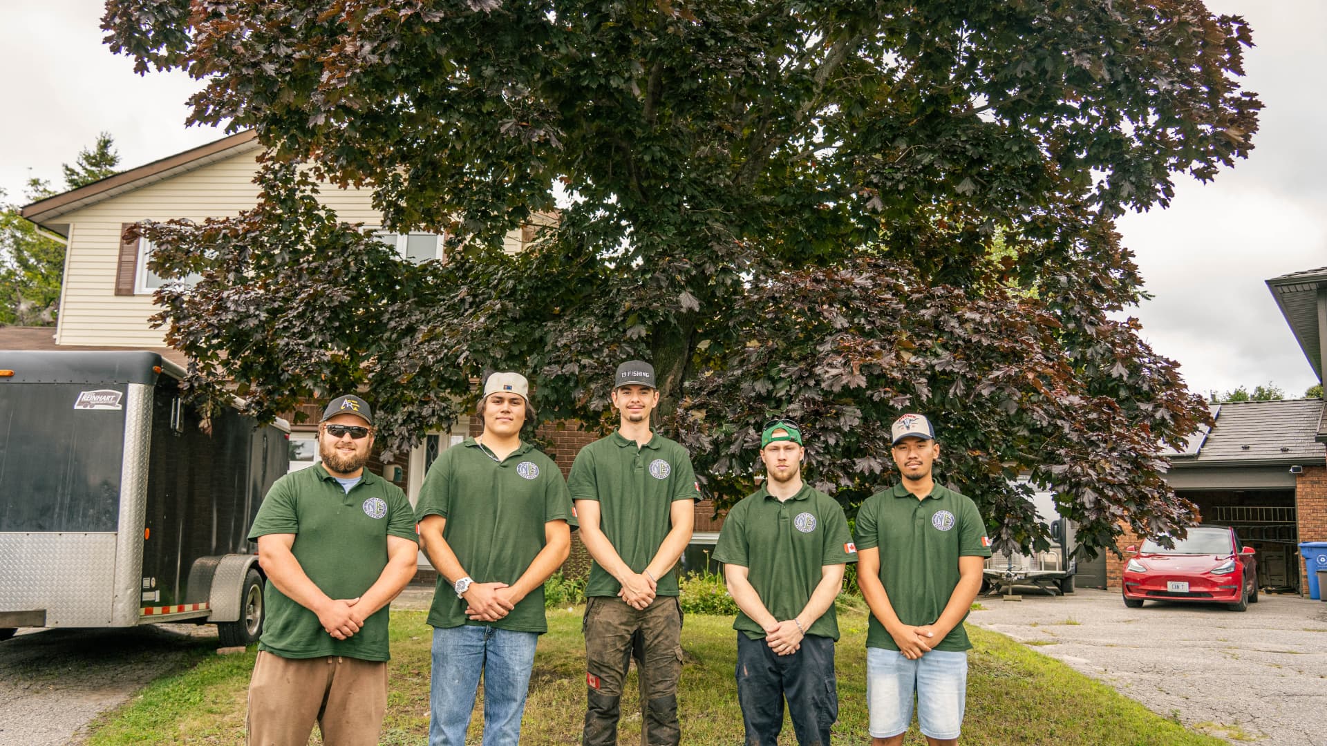 The Nipissing Exteriors crew standing together in front of a North Bay home